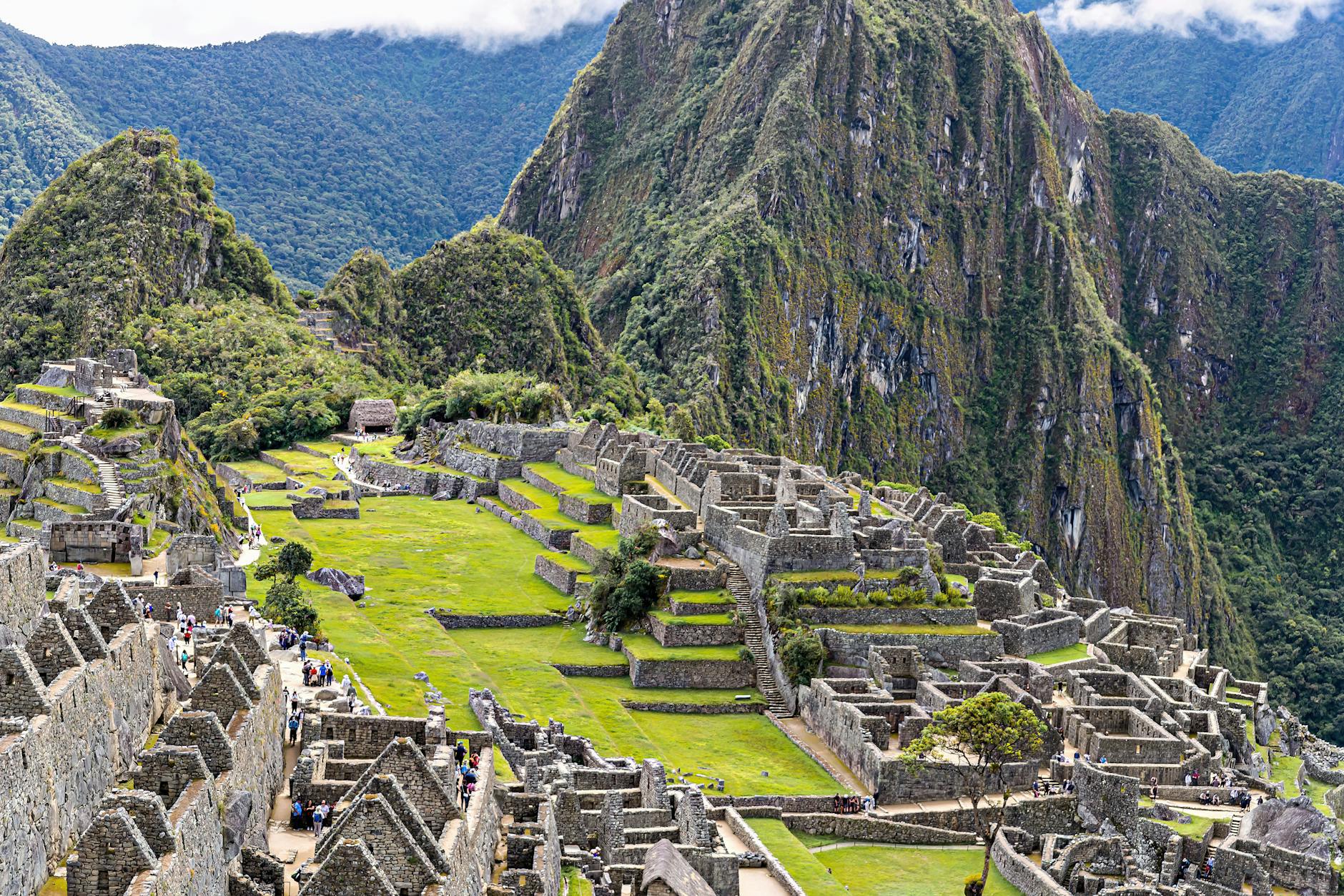 Explore the stunning ancient ruins of Machu Picchu surrounded by lush green mountains.